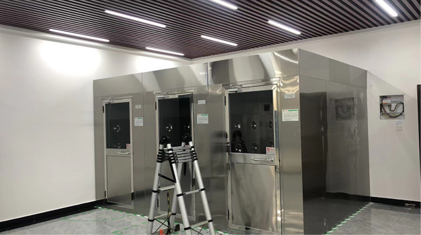 Cleanroom air shower system in operation with personnel undergoing decontamination